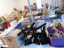 A smattering of estate sale supplies such as jewelry racks, shoe covers, shoe cover system, table top easels, tape, bins, baskets....