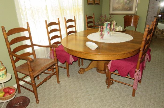 GOLDEN OAK CLAW FOOT TABLE AND 6 CHAIRS AND TWO LEAVES