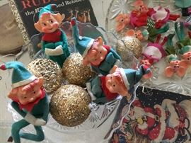 Vintage knee hugging elf ornaments.
