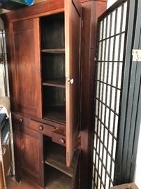 Primitive corner cabinet