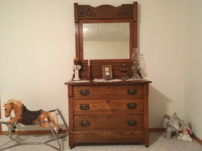 3 drawer (with mirror) antique wooden dresser in great condition.  Children spring horse and pottery elephant also for sale. Along with the lamps on the dresser