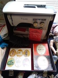 Viking sewing machine with books and case.