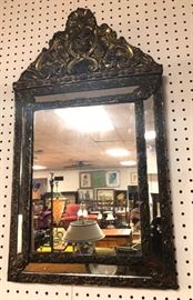 Lot 248 Repousse Metal Mirror with Decorative Crest. 