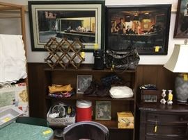 Wooden shelf filled with collectibles, pictures