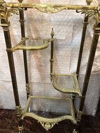 Elegant  brass étagère with decorative acanthus leave accents with curved Dolphin feet