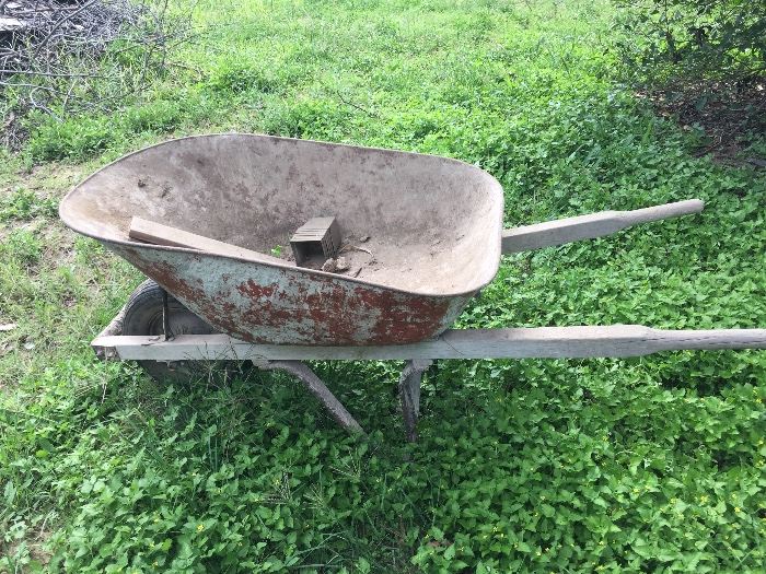 vintage wheelbarrow ready for plants with water holes