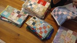 Many hand made baby quilts