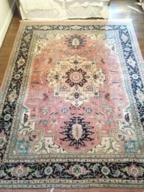 Hand woven Persian Heriz design rug, 100% wool face, measures 9' x 12'.