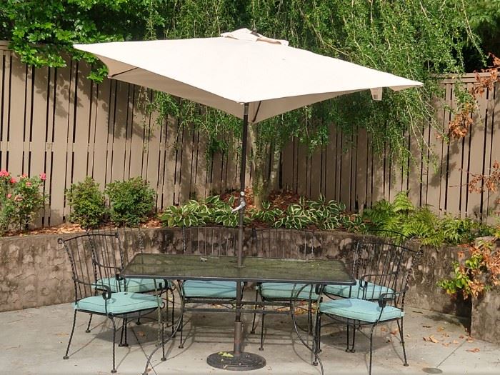 Another very nice vintage wrought iron outdoor furniture set, this one rectangular with six matching armchairs, umbrella and stand.                                       Florence hasn't hit yet, but the umbrella is practicing! 