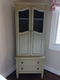 Sweet little MCM celery green, two-piece French Provincial wooden cabinet with metal grill doors above and two drawers below.  