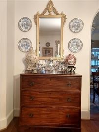 Antique 3-drawer English mahogany chest, from Joseph Konrad Antiques.                                                                              Nice, vintage LaBarge gold gilt Italian mirror above a silverplated gallery tray and tea set.