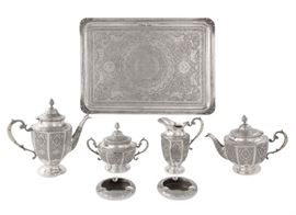 Lot 6 An assembled Persian 84 standard silver seven piece tea and coffee service with tray  
20th century 
Comprising: a teapot, a coffee pot, a cream jug, a sugar bowl, two ashtrays and a rectangular tray  