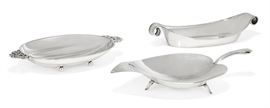 Lot 18 Three American sterling silver Modernist bowls  
By Tiffany & Co., New York, NY, 20th century 
Comprising: a footed leaf form dish, an oval fluted two handled dish and an oval scroll handle dish  