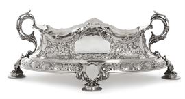Lot 20 A monumental Edward VII sterling silver oval footed two-handled centerpiece bowl  
By Atkin Brothers, Sheffield, 1901 
