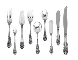 Lot 30 An American sterling silver part flatware service for twelve  
By Wallace Silversmiths, Wallingford, CT, 20th century 
Sir Christopher pattern, comprising: 12 luncheon forks, 12 luncheon knives, 10 salad/dessert forks, 6 butter spreaders, 10 round bowl soup spoons, 6 cocktail forks, 10 teaspoons, 1 master butter knife (67)  
with a canteen  