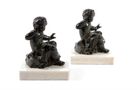Lot 32 A pair of Continental patinated bronze figures of seated putti 
late 19th century 
Raised on rectangular marble plinths.  