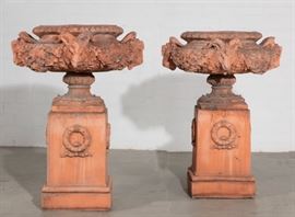 Lot 53 A pair of Neoclassical style tinted terracotta jardinières on pedestals 
20th century 