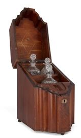 Lot 58 A George III inlaid mahogany knife box 
late 18th century 
The interior now fitted with three later glass decanters and stoppers.  