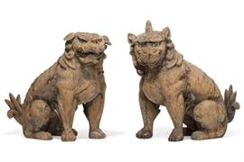Lot 62 A pair of Japanese wooden Shinto lion dogs (koma inu)  
Possibly 19th century 
With glass eyes, probably originally lacquered or paint decorated.  