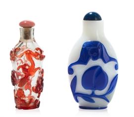 Lot 66 Two Chinese overlay glass snuff bottles  
19th-20th century 
One with milky white ground and blue overlay decoration of bats amidst fruiting vines; the other clear glass with red overlay decoration of chilong.  