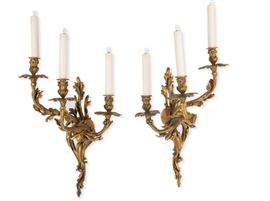 Lot 100 A pair of Louis XV style gilt bronze three light bras de lumière 
attributed to Raingo Frères 
late 19th century 
Each numbered 2012.  