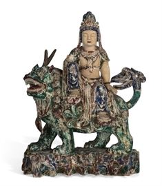 Lot 105 A large polychrome decorated figure of Guanyin seated on a temple lion 