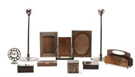 Lot 132 A collection of eleven Arts & Crafts and Art Deco silver, copper and metalware desk accessories 
By Gustav Stickley, Heinz and various other makers 
early 20th century 
Comprising a Gustav Stickley stamp box, a Heinz letter rack, monogram ERD, a cigarette box and two picture frames, another box, probably formerly lined, an inkwell and similar pair of candlesticks, a mirrored table clock and a picture frame.  