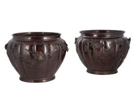 Lot 65 A matched pair of Japanese bronze jardinières 
Decorated overall with birds amidst clouds and branches.