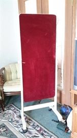 Lovely painted wood frame mirror with red velvet back and casters.