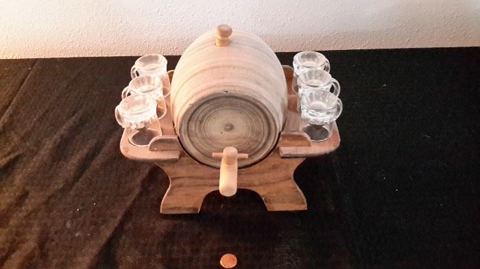 Heavy ceramic liquor barrel with 6 shot glasses on wood base.