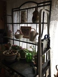 Metal baker's/gardener's rack with glass shelves and stone tile shelf.