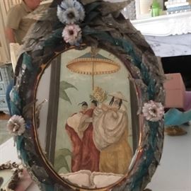 Antique oval decorated framed mirror.
