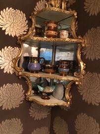 Mirrored antique hanging cabinet with antique luster ware.