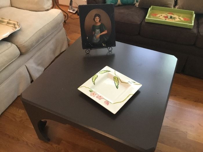 Coffee table with a poignant portrait of a lady and her cat.