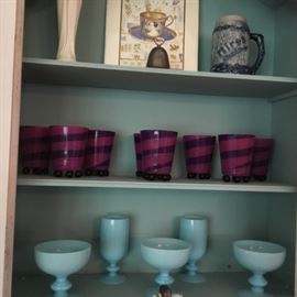 Blue glassware, purple votives in a wonderful hanging cabinet.