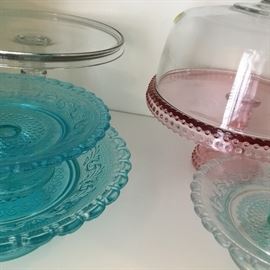 Pink and blue glass including a pink covered cake dish.