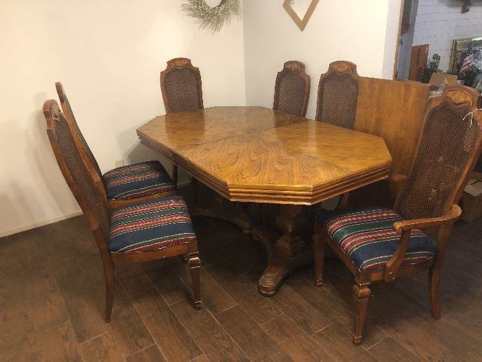 Dining room table with four chairs and two armchairs