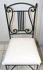 Arhaus cast iron chair with musical theme detail.