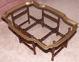 Japanese style glass table with chrome edges and wooden legs. 38" Length x 27.5" Width x 16" Height.