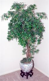 Faux tree with ceramic pot and wooden stand.