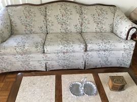 Two floral sofas, large and smaller. 