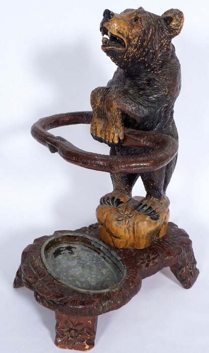 Carved full figure paint decorated bear with glass eyes, holding support ring, on base with 4 legs, tin insert.  Overall 28.5" h. x 16.5" x 20".  Condition:  Loss of paint, other wear consistent with age and use.
