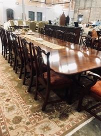 Outstanding antique dining table, banded and Ebony inlaid Mahogany, with triple pedestal four legged Duncan Phyfe brass toed feet. Total measurement is 157"L  x 59" W, with one middle leaf measuring 52" L.