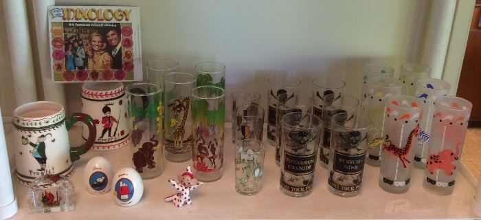 Festive drinking glasses including jungle theme set, 6 Georges Briard "Name Your Poison" glasses, 6 Libbey frosted circus glasses, Peanuts S & P set, lucite S & P set with pheasant, tiny red polka dot clown figurine