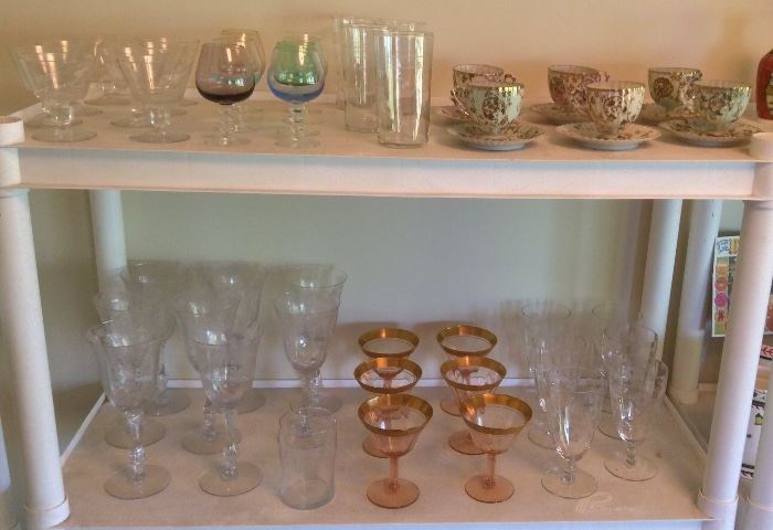 Vintage stemware including set of 8 Cambridge Rosepoint water goblets, pink champagnes with gold rim, set of 8 colored aperitif glasses, 4 etched polka dot glasses, footed cups & saucers with ornate gold designs