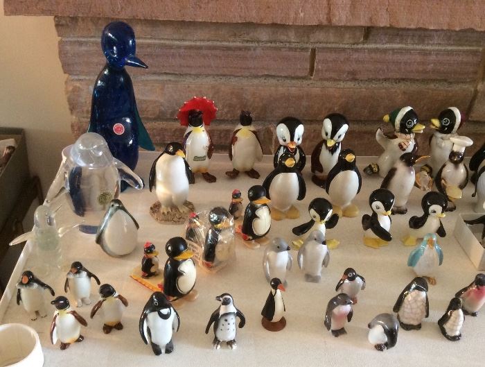 Detail of penguins - Italian blue glass penguin, Beswick pair with red umbrella, plastic ramp walkers, lots of ceramic ones in all sizes