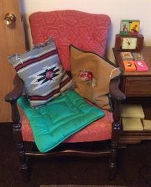 Pink chair, vintage pillows, playing cards including Peanuts