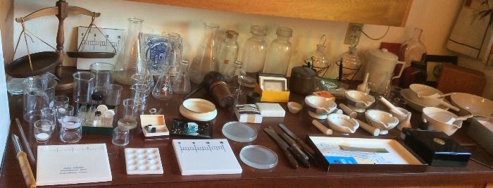 More pharmacy items: flasks, funnels, mortar & pestles, wooden balance, tablets counters