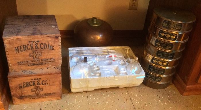 Merck wooden crates, glass lab set, copper tablet coater, stack of vintage screen sieves