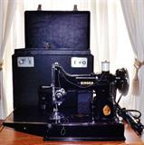 Singer portable Featherweight 221 sewing machine with original carrying case with extra parts and bobbins, etc.